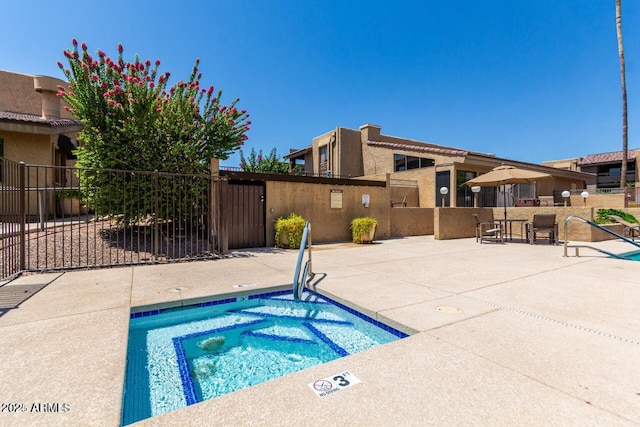 view of pool featuring a patio and a hot tub