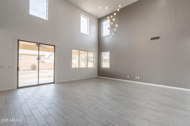 694 W Desert Seasons Dr, San Tan Valley, AZ 85143 - empty room with a high ceiling, light wood finished floors, and a ceiling fan