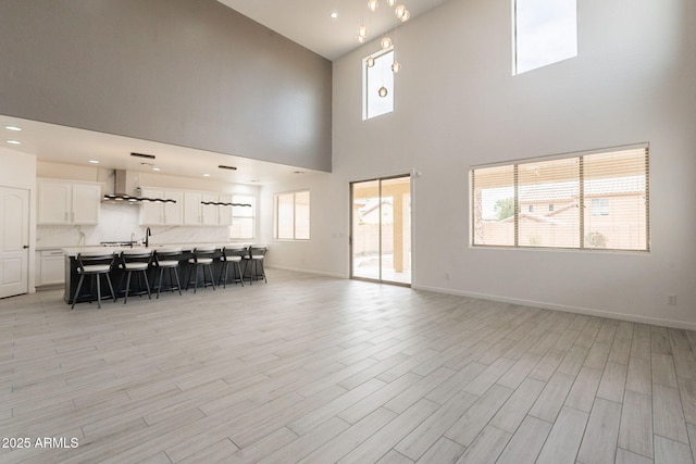 694 W Desert Seasons Dr, San Tan Valley, AZ 85143 - living room featuring high vaulted ceiling, healthy amount of natural light, and light wood finished floors
