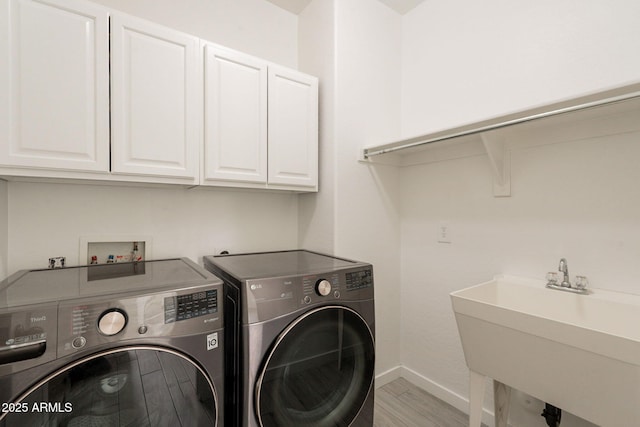 694 W Desert Seasons Dr, San Tan Valley, AZ 85143 - laundry room with cabinet space, washer and dryer, and light wood-style floors