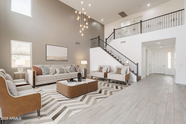 694 W Desert Seasons Dr, San Tan Valley, AZ 85143 - living room featuring a towering ceiling, stairs, plenty of natural light, wood finished floors, and recessed lighting