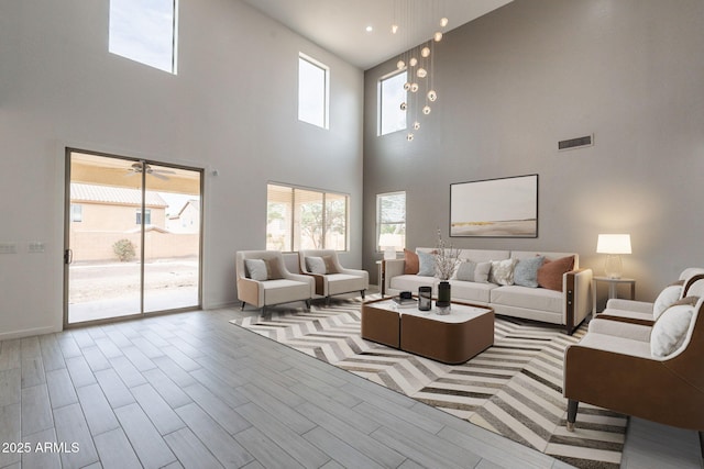 694 W Desert Seasons Dr, San Tan Valley, AZ 85143 - living room with a high ceiling, plenty of natural light, and wood finished floors