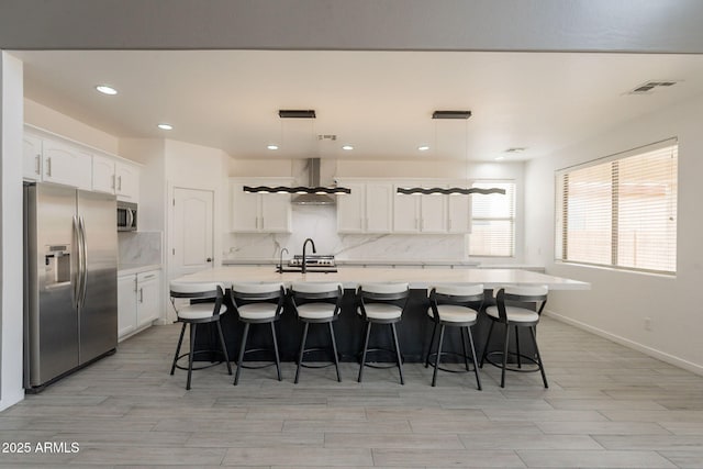 694 W Desert Seasons Dr, San Tan Valley, AZ 85143 - kitchen featuring appliances with stainless steel finishes, wall chimney exhaust hood, decorative backsplash, light countertops, and recessed lighting