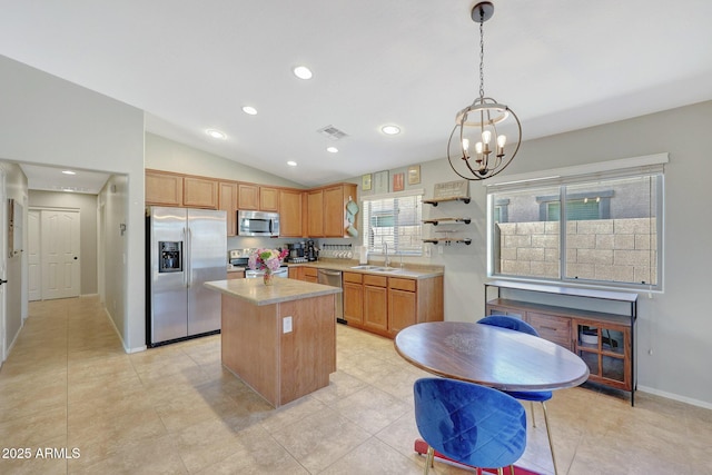 18590 W Vogel Ave, Goodyear, AZ 85338 - kitchen featuring vaulted ceiling, light countertops, visible vents, appliances with stainless steel finishes, and a sink