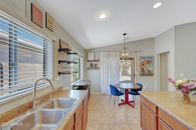 18590 W Vogel Ave, Goodyear, AZ 85338 - kitchen with vaulted ceiling, light tile patterned flooring, a sink, decorative light fixtures, and brown cabinets