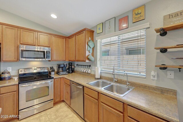 18590 W Vogel Ave, Goodyear, AZ 85338 - kitchen featuring light tile patterned floors, a sink, light countertops, appliances with stainless steel finishes, and vaulted ceiling