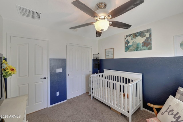 18590 W Vogel Ave, Goodyear, AZ 85338 - bedroom with ceiling fan, a nursery area, a closet, visible vents, and carpet floors