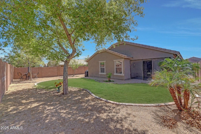 18590 W Vogel Ave, Goodyear, AZ 85338 - back of house with a yard, a patio, stucco siding, and a fenced backyard