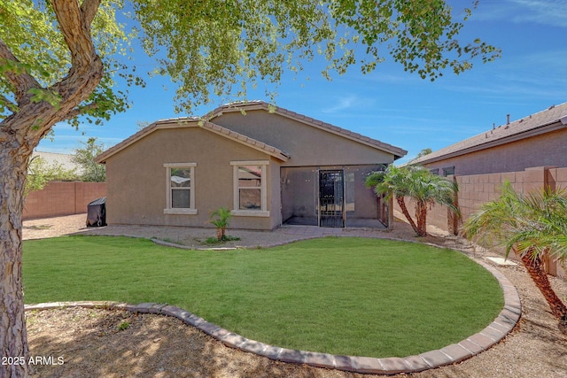 18590 W Vogel Ave, Goodyear, AZ 85338 - back of house featuring stucco siding, a fenced backyard, a lawn, and a tile roof