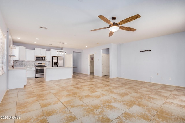 unfurnished living room featuring light tile patterned floors, visible vents, a ceiling fan, a sink, and recessed lighting