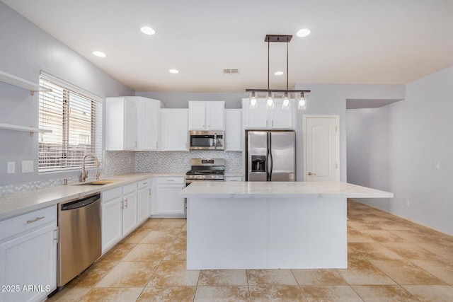 kitchen featuring stainless steel appliances, a sink, decorative backsplash, a center island, and open shelves