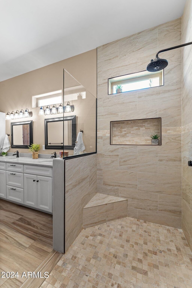 bathroom with vanity and tiled shower