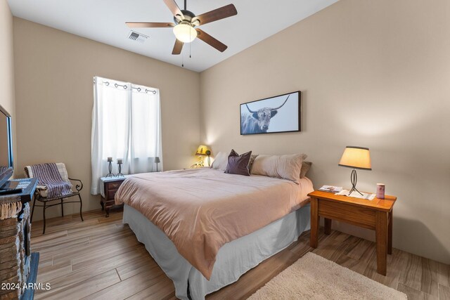 bedroom with ceiling fan and light hardwood / wood-style floors