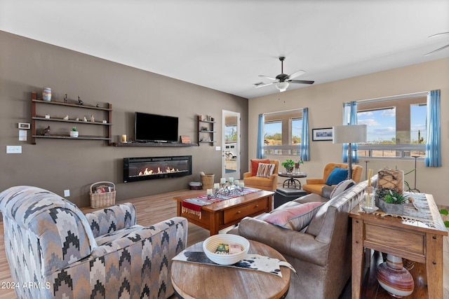 living room featuring hardwood / wood-style flooring and ceiling fan