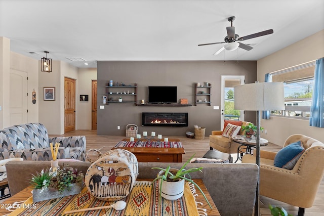 living room with light hardwood / wood-style floors and ceiling fan