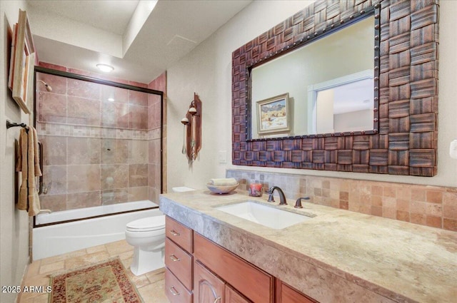 18738 E Buckskin Dr, Rio Verde, AZ 85263 - full bath with toilet, enclosed tub / shower combo, stone tile flooring, tasteful backsplash, and vanity