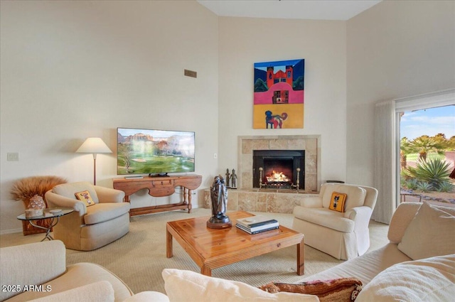 18738 E Buckskin Dr, Rio Verde, AZ 85263 - carpeted living area with a towering ceiling, a tile fireplace, and baseboards