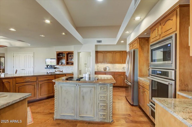 18738 E Buckskin Dr, Rio Verde, AZ 85263 - kitchen featuring appliances with stainless steel finishes, light wood-style floors, light stone counters, a center island, and recessed lighting