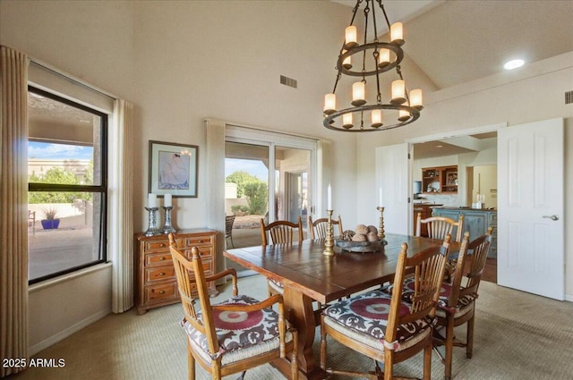 18738 E Buckskin Dr, Rio Verde, AZ 85263 - dining room with light carpet, high vaulted ceiling, and a chandelier