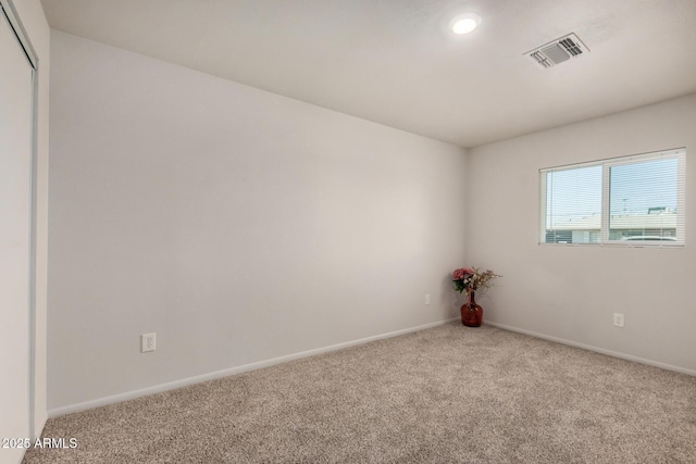 carpeted empty room with recessed lighting, visible vents, and baseboards