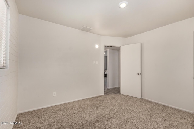 empty room with baseboards and carpet flooring