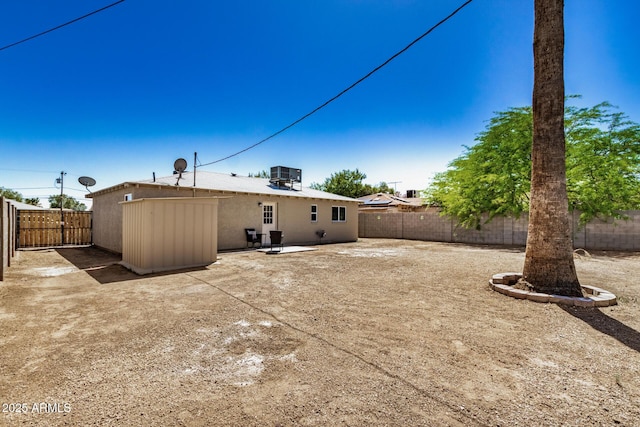 back of house featuring central air condition unit, a fenced backyard, and a patio area