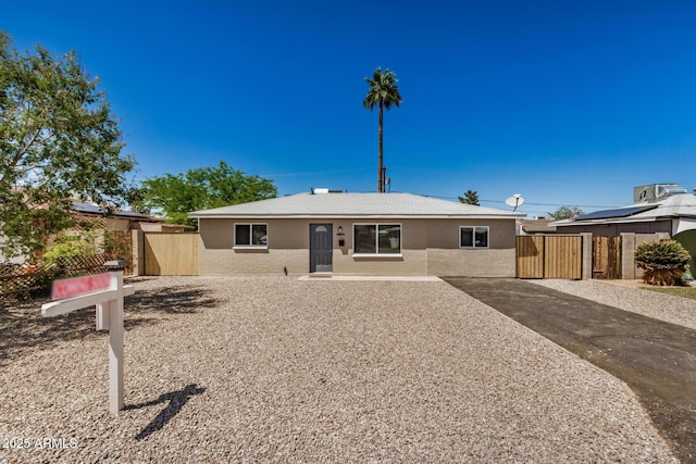 view of front of home featuring fence and a gate