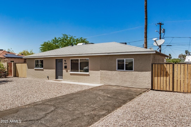 single story home with brick siding and fence