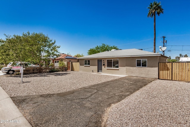 single story home featuring fence and stucco siding