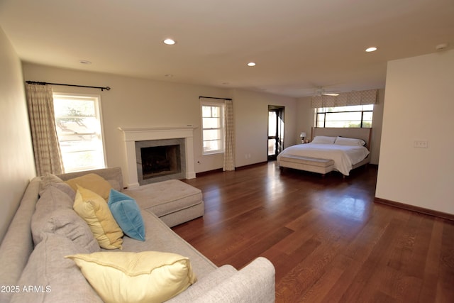 bedroom with multiple windows and dark wood-type flooring