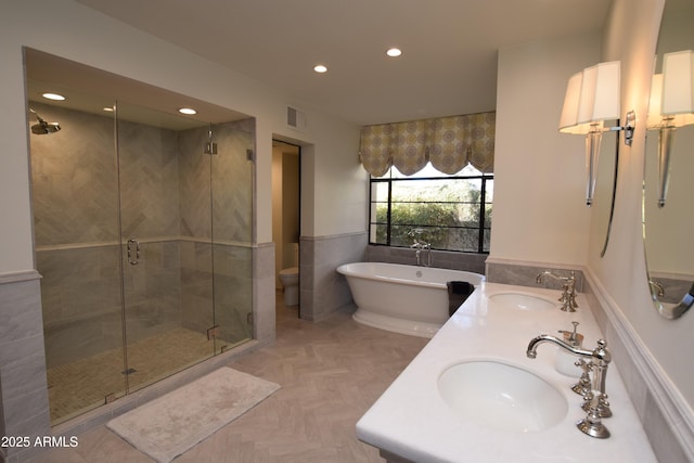 full bathroom with separate shower and tub, parquet flooring, vanity, and toilet