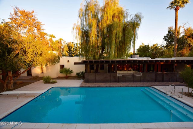 view of swimming pool with a patio area