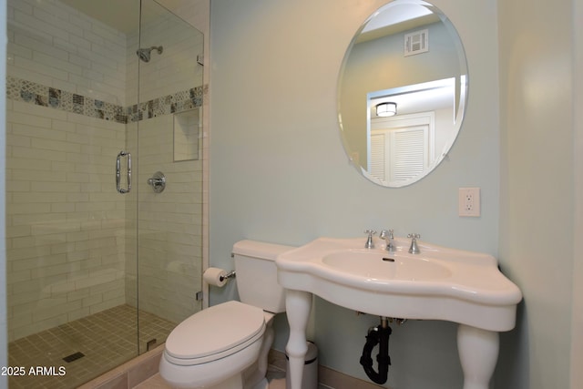 bathroom featuring an enclosed shower and toilet