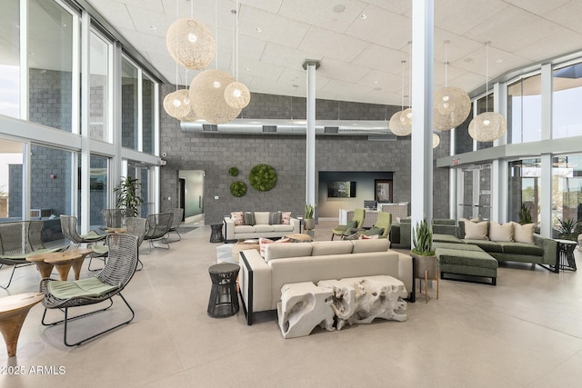 11946 W Calle De Pompas, Peoria, AZ 85383 - lobby with a high ceiling, a wall of windows, and brick wall