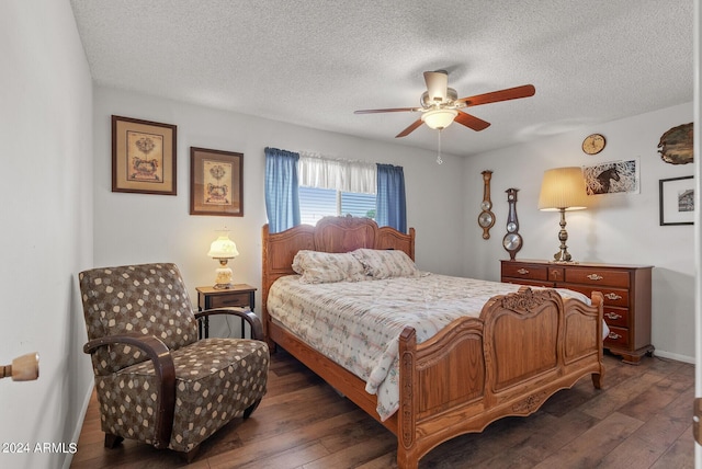 bedroom with ceiling fan, dark hardwood / wood-style flooring, and a textured ceiling