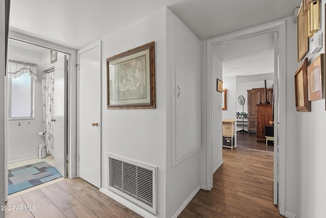 corridor with light hardwood / wood-style flooring