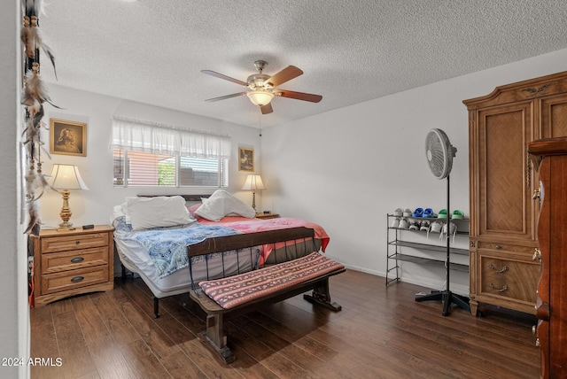 bedroom with a textured ceiling, ceiling fan, and dark wood-type flooring