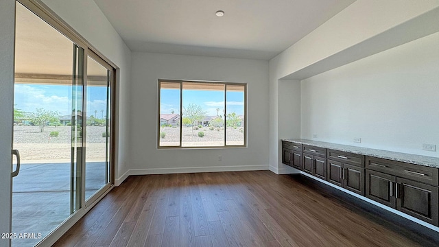 16777 W Sheila Ln, Goodyear, AZ 85395 - unfurnished room with dark wood-style floors and baseboards