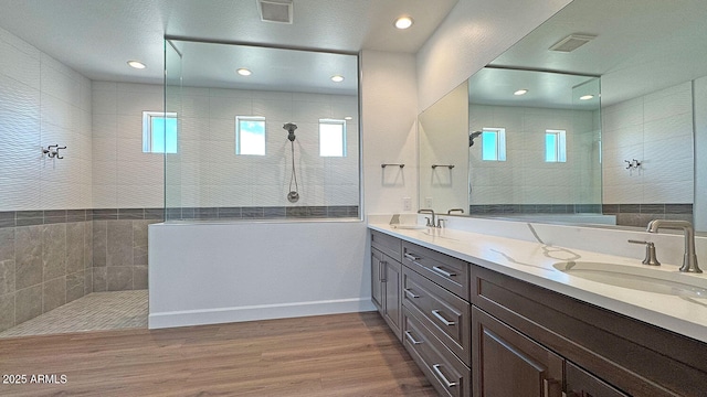 16777 W Sheila Ln, Goodyear, AZ 85395 - full bathroom with double vanity, walk in shower, wood finished floors, and recessed lighting