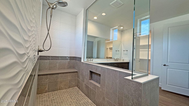 16777 W Sheila Ln, Goodyear, AZ 85395 - full bathroom featuring a tile shower, double vanity, wood finished floors, and recessed lighting