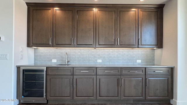 16777 W Sheila Ln, Goodyear, AZ 85395 - kitchen with wine cooler, decorative backsplash, and light countertops