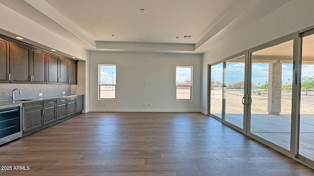 16777 W Sheila Ln, Goodyear, AZ 85395 - kitchen with healthy amount of natural light, wine cooler, and dark wood-style floors