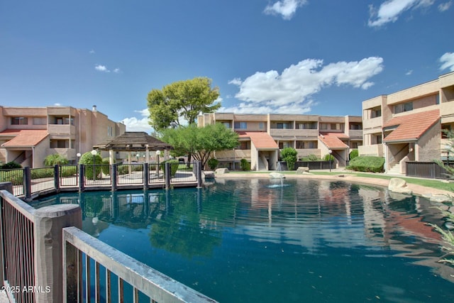 view of swimming pool featuring a residential view