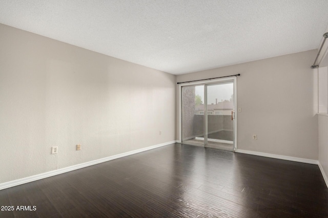 unfurnished room featuring a textured ceiling, dark wood finished floors, and baseboards