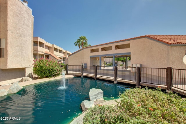 view of pool featuring fence