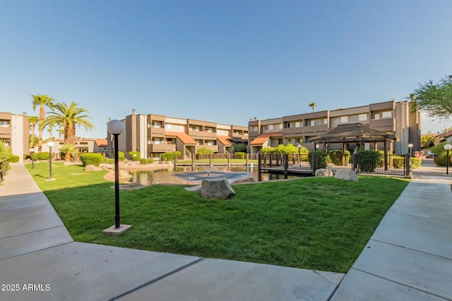 view of property's community with a gazebo, a residential view, and a yard