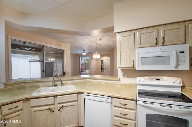 kitchen with white appliances, a ceiling fan, light brown cabinetry, and a sink