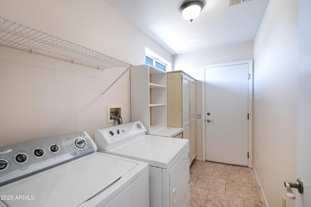 clothes washing area with laundry area, baseboards, and independent washer and dryer
