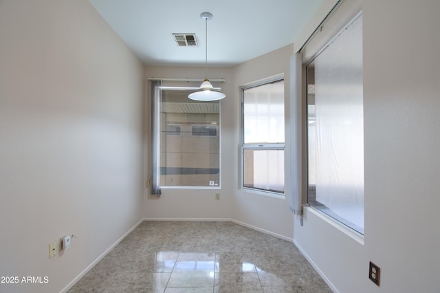 unfurnished dining area featuring baseboards and visible vents