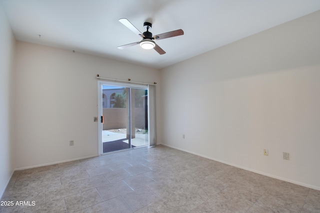 empty room featuring a ceiling fan and baseboards